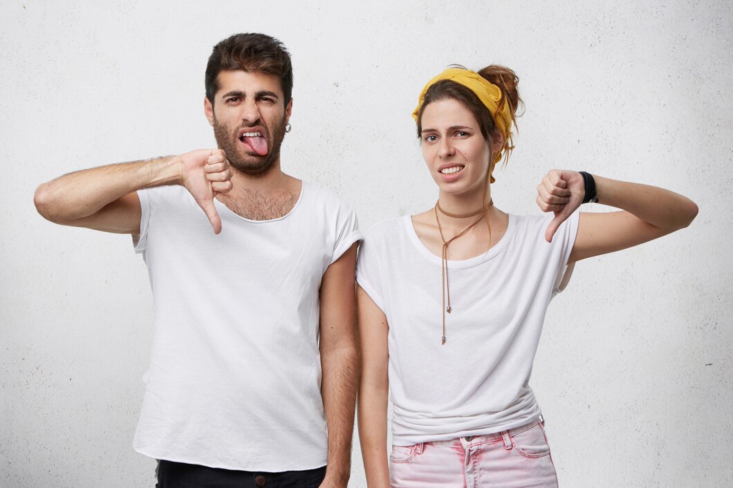 annoyed-disgusted-young-european-couple-wearing-stylish-clothing-expressing-dislike-disapproval-disrespect-disregard-with-gestures-showing-thumbs-down-grimacing_273609-7976.jpg