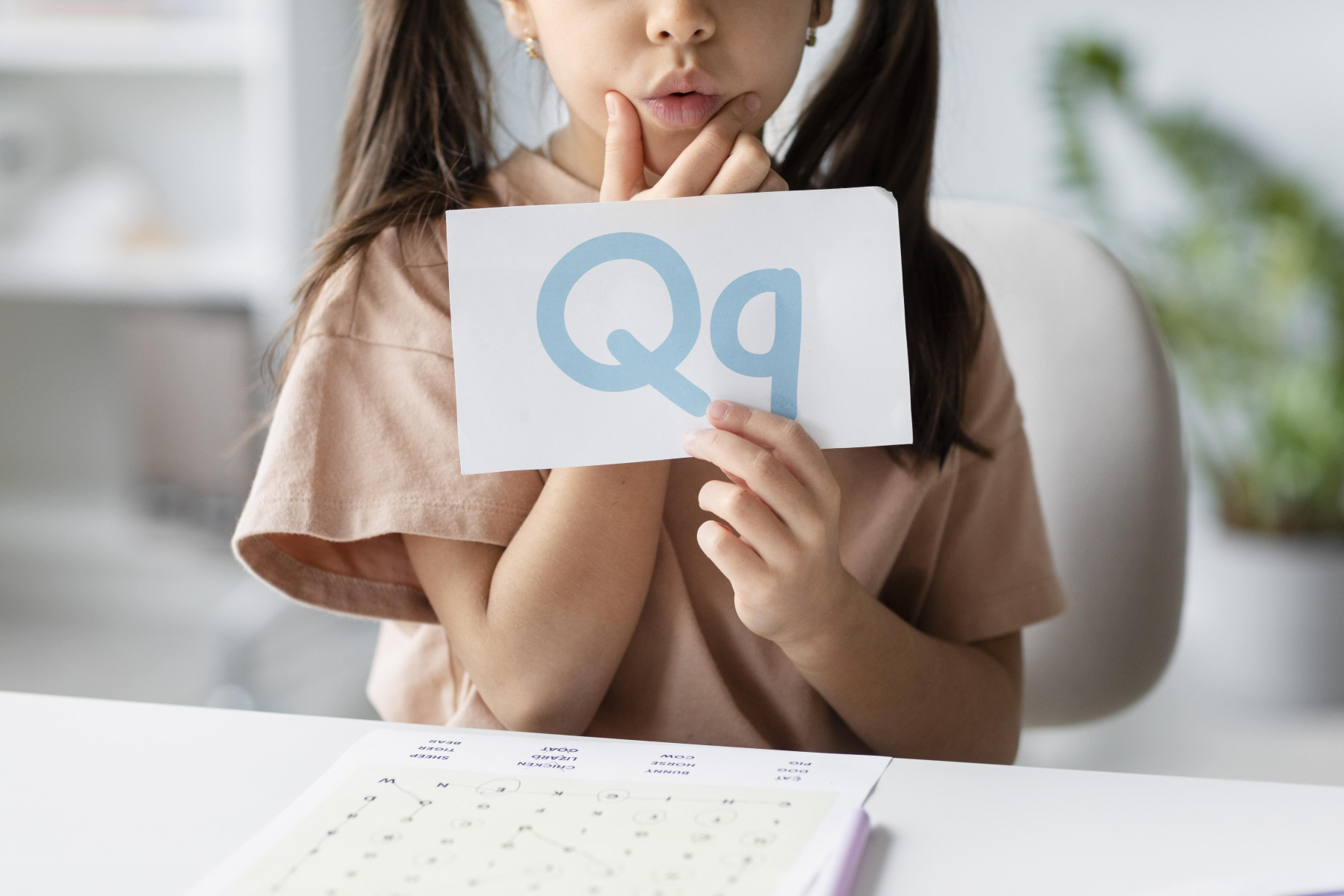little-girl-holding-paper-with-letter-it-speech-therapy.jpg