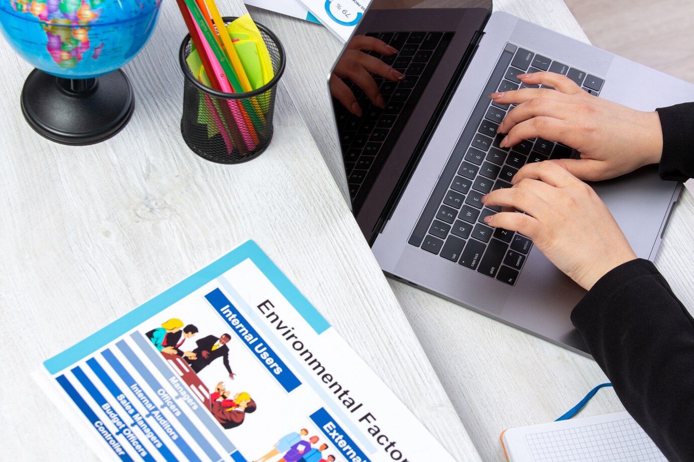 a_front_view_girl_using_laptop_in_front_of_table_with_schedules.jpg a_front_view_girl_using_laptop_in_front_of_table_with_schedules.jpg
