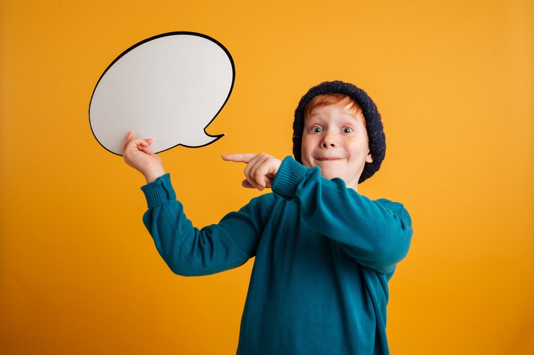 cheerful-little-redhead-boy-holding-speech-bubble_171337-1661.jpg