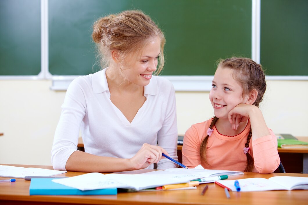 teacher-helping-young-girl-with-writing-lesson_1098-1861.jpg