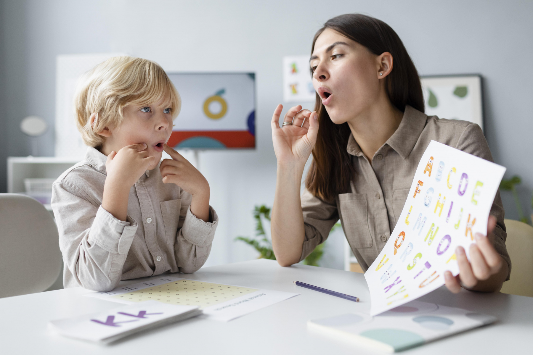 woman-doing-speech-therapy-with-a-little-blonde-boy.jpg