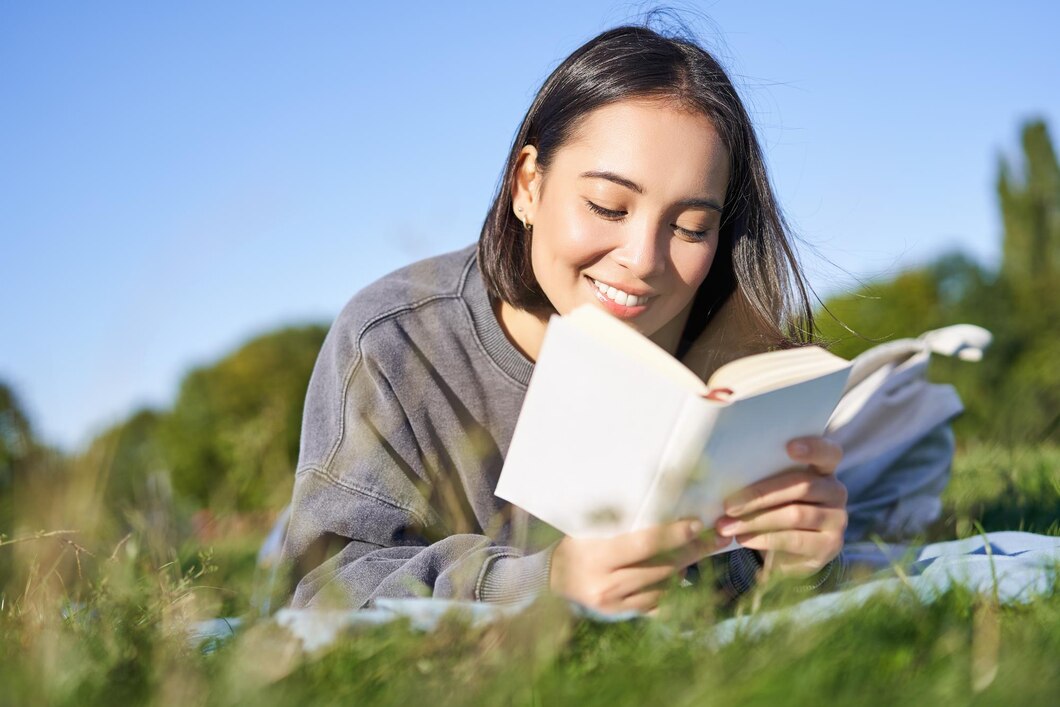 portrait-cute-korean-girl-reading-park-while-lying-grass-relaxing-with-favorite-book-han_1258-134366.jpg